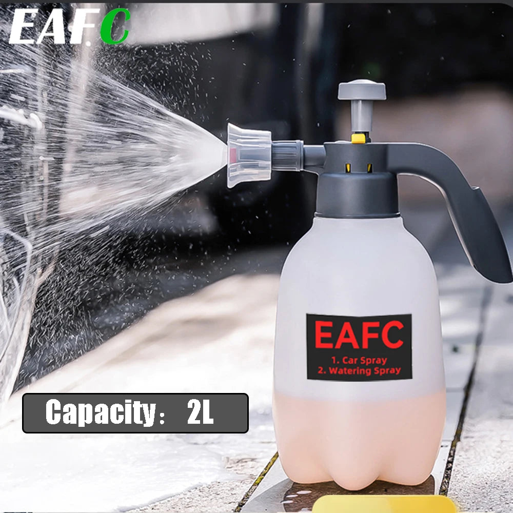 A white hand pump foam sprayer with a green cap is shown spraying water onto a surface.