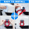 Hands install a red decorative racing tow hook sticker onto a car bumper.