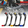 A set of black carbon fiber motorcycle hand guards and lever protectors with red and blue accents.
