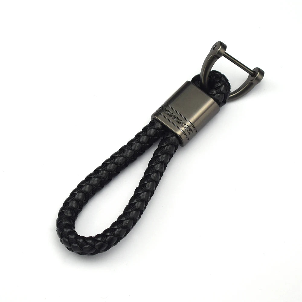 A dark brown braided leather key case cover with a metal clasp and loop.