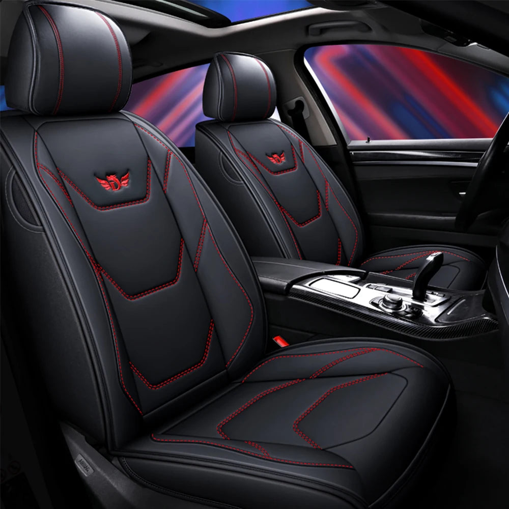 Black leather car seat covers installed in a vehicle interior with red stitching and a blue light background.