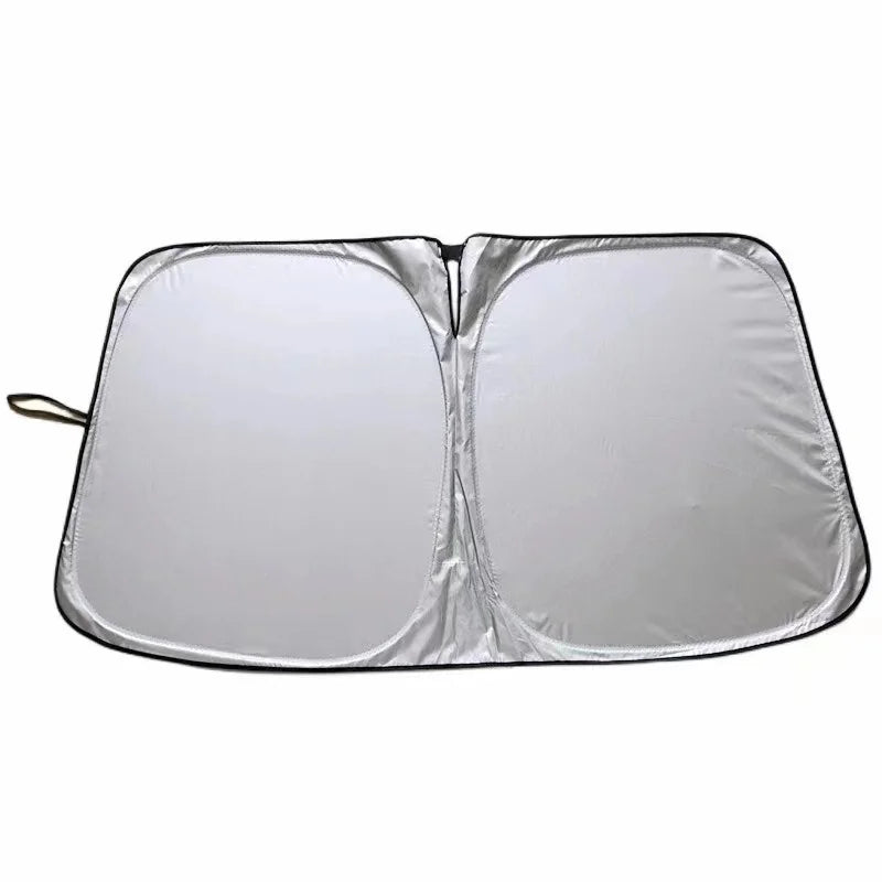 A silver foldable car windshield sun shade is shown open, displaying its reflective surface.