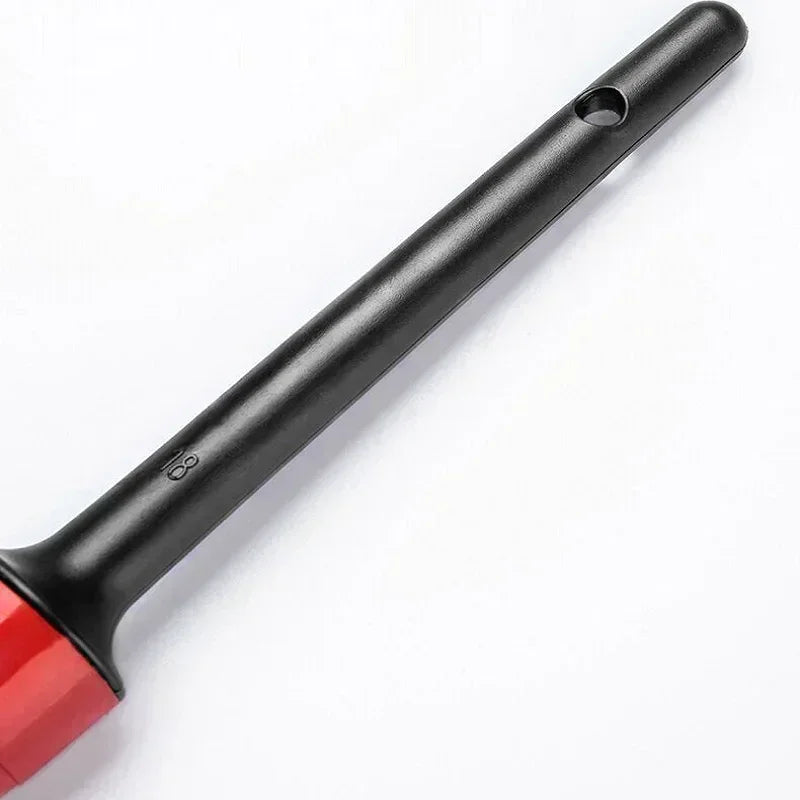 A black professional car detailing brush with a red handle and a long, slender shaft.
