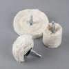 A light beige polishing wheel with a metal shank is shown next to a rolled-up version.