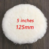 A round, white, fluffy polishing disc measuring 5 inches or 125mm resting on a dark wooden surface.