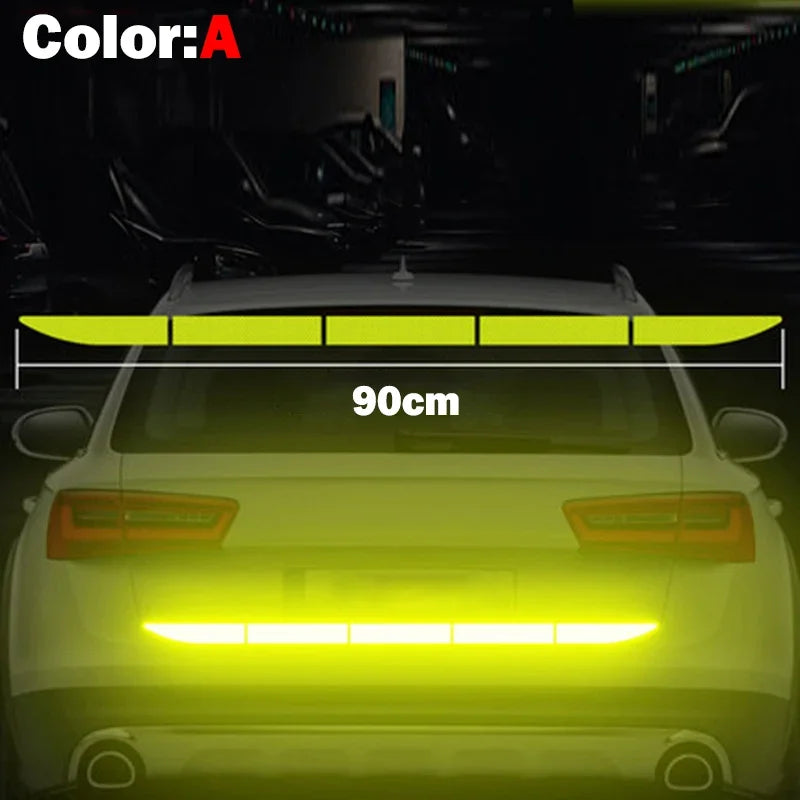 Rear view of a white car showing yellow LED safety strips and taillights.