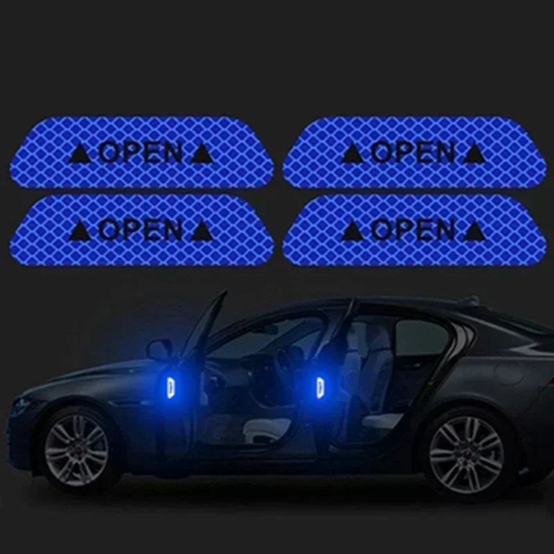 Four reflective decals showing an open door warning symbol applied to a black car door.