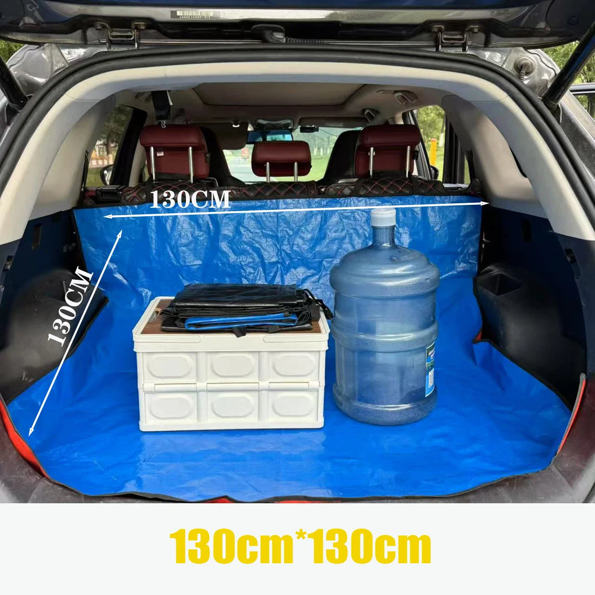 Blue waterproof car trunk liner mat with storage compartments and a large blue jug inside the trunk.