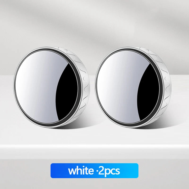 Two round white 360 degree rotatable car blind spot mirrors displayed on a light surface.