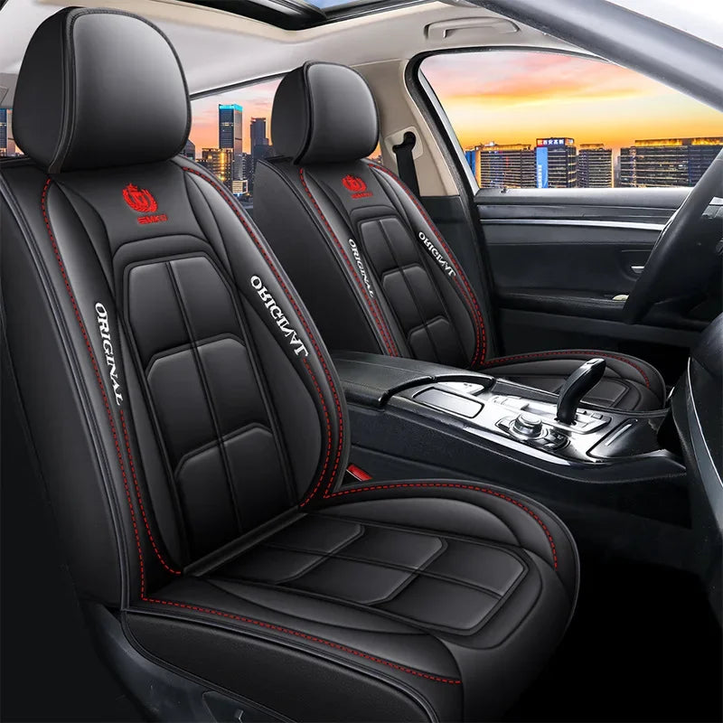 Black leather car seat covers with red stitching and headrests shown inside a car cabin.