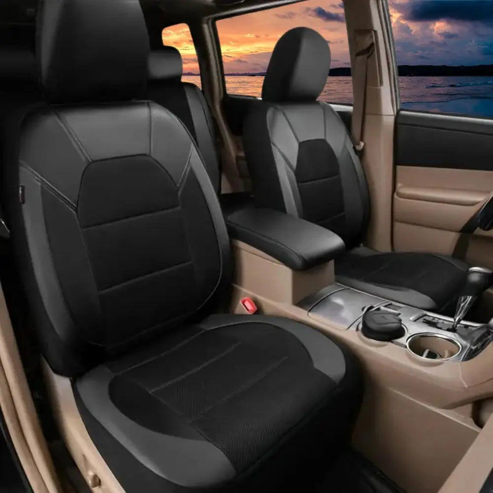 Interior view of a car showing black PU leather seat covers on the front seats with an orange sunset visible through the wind