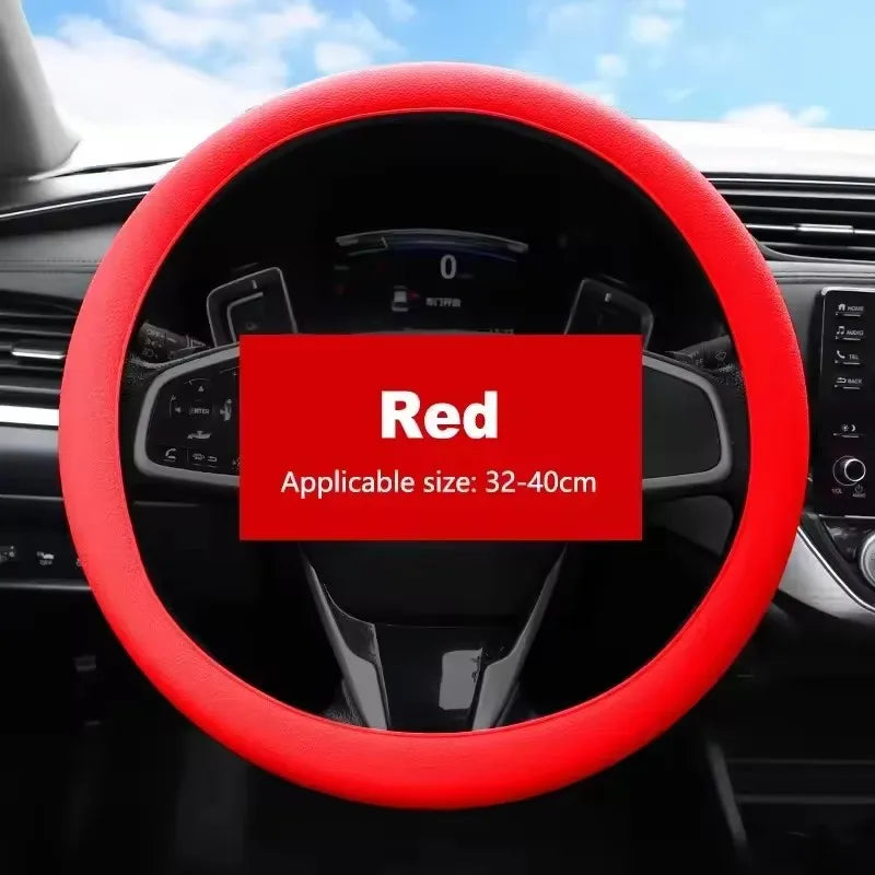 Red universal silicone steering wheel cover installed in a car interior.