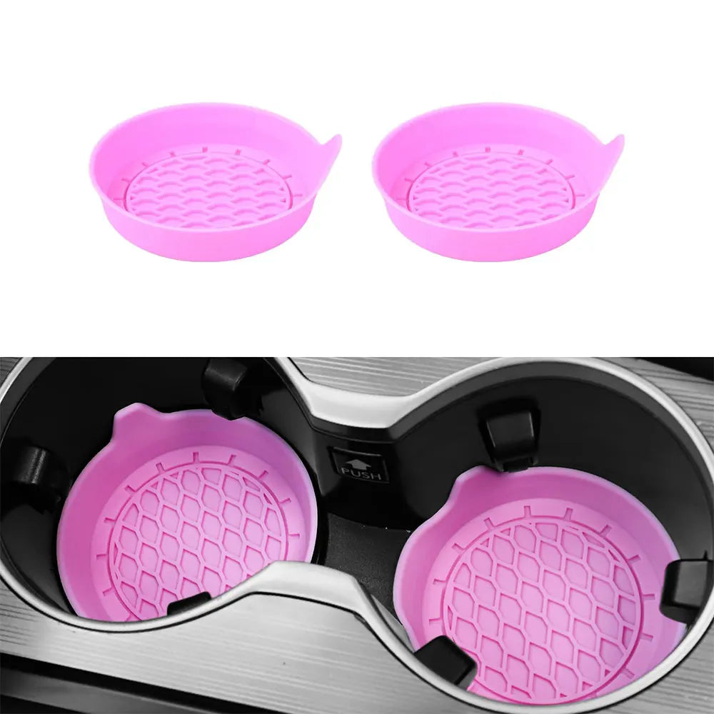 A pair of pink silicone cup holder coasters shown separately and inside a black cup holder.