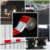 Rolls of high-visibility reflective safety tape shown in various contexts including a vehicle, a flatbed trailer, and packagi