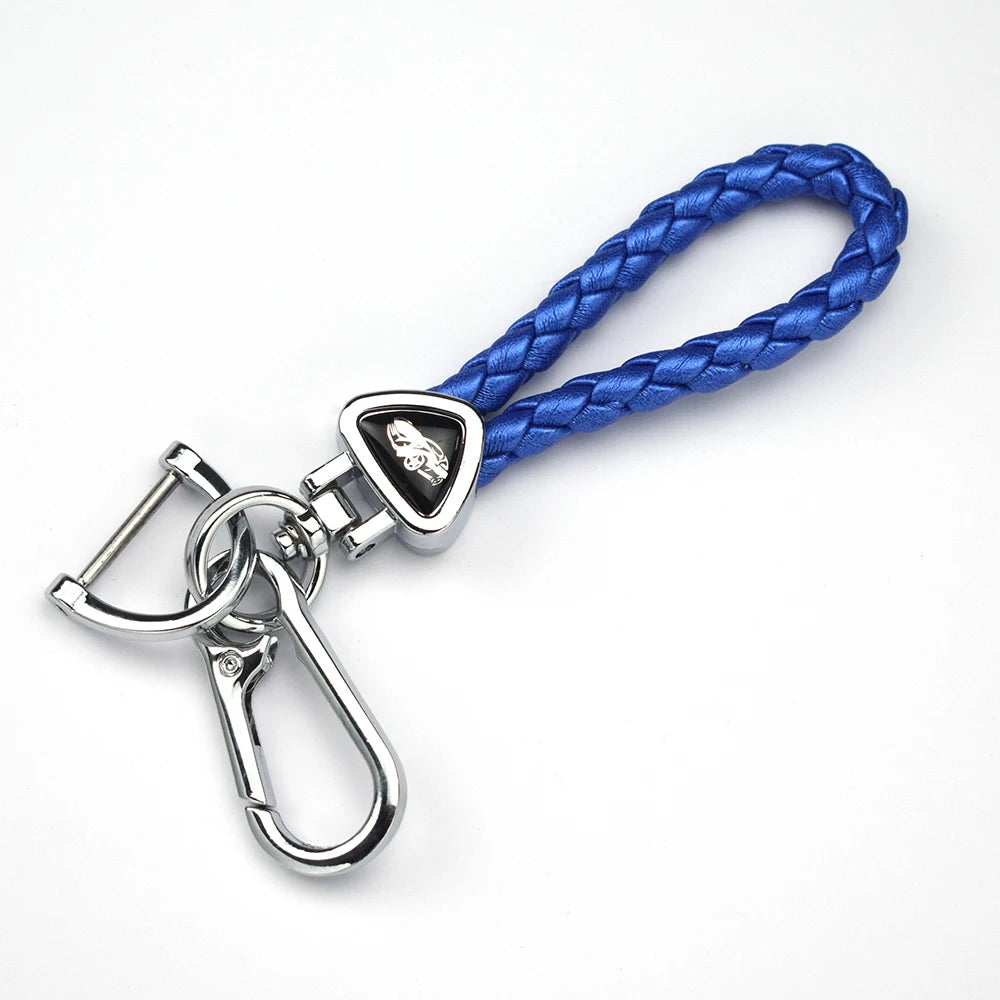 A silver key fob attached to a blue braided leather strap, used as a universal car key case cover.