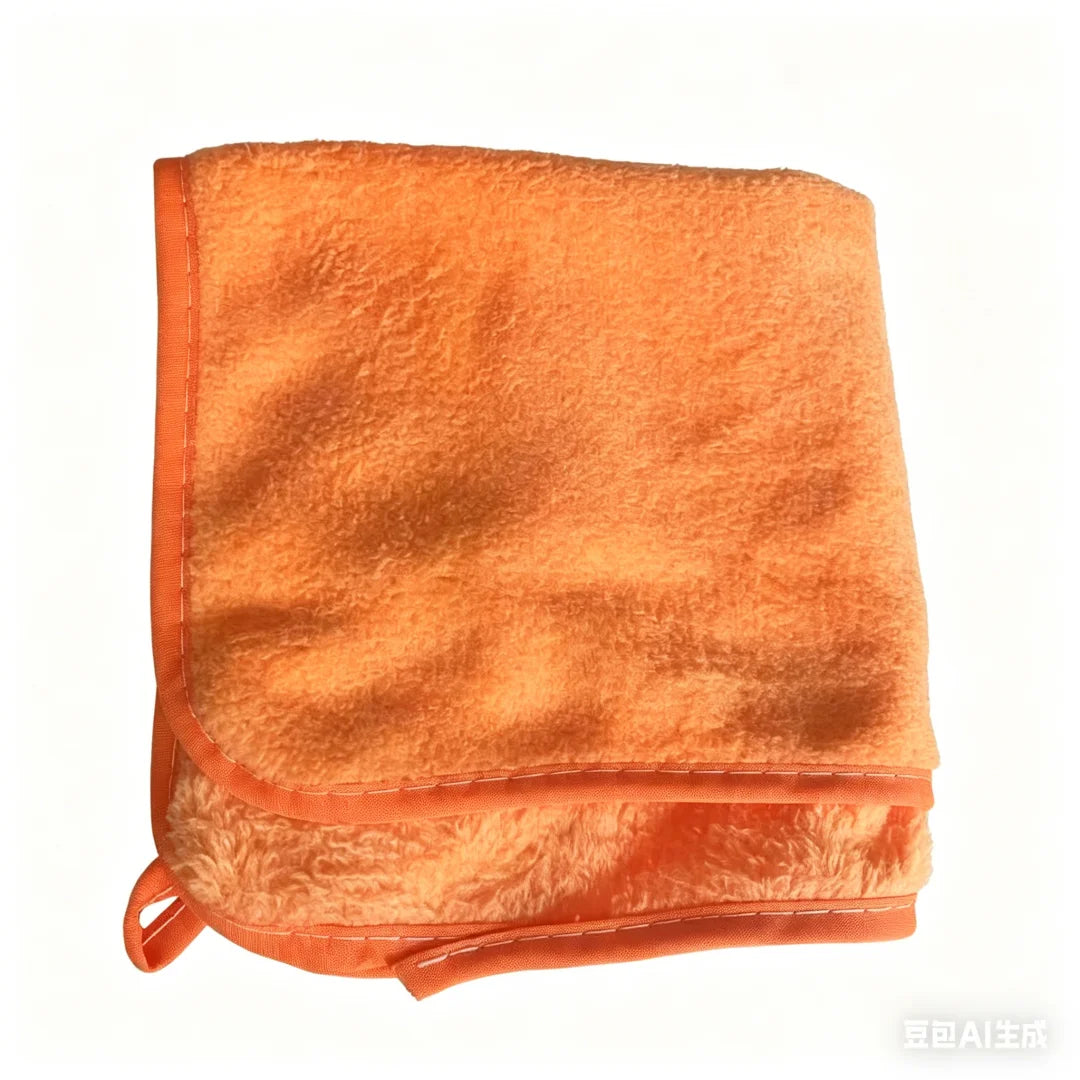 An orange microfiber car cleaning towel set folded and displayed.