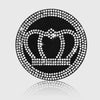 A circular black coaster design featuring a crown outline made of sparkling imitation diamonds.