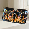 A black car windshield sunshade featuring four happy German Shepherd dogs wearing sunglasses.