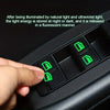 A hand presses a green luminous button on a black car window decal.