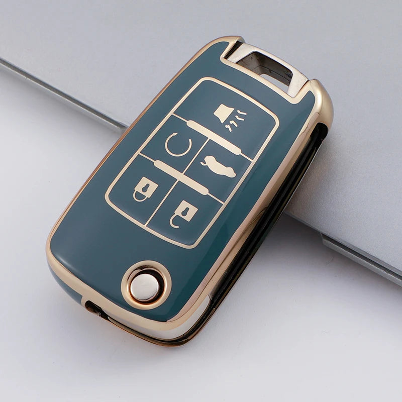 A teal TPU key fob case with gold accents showing various key shapes.