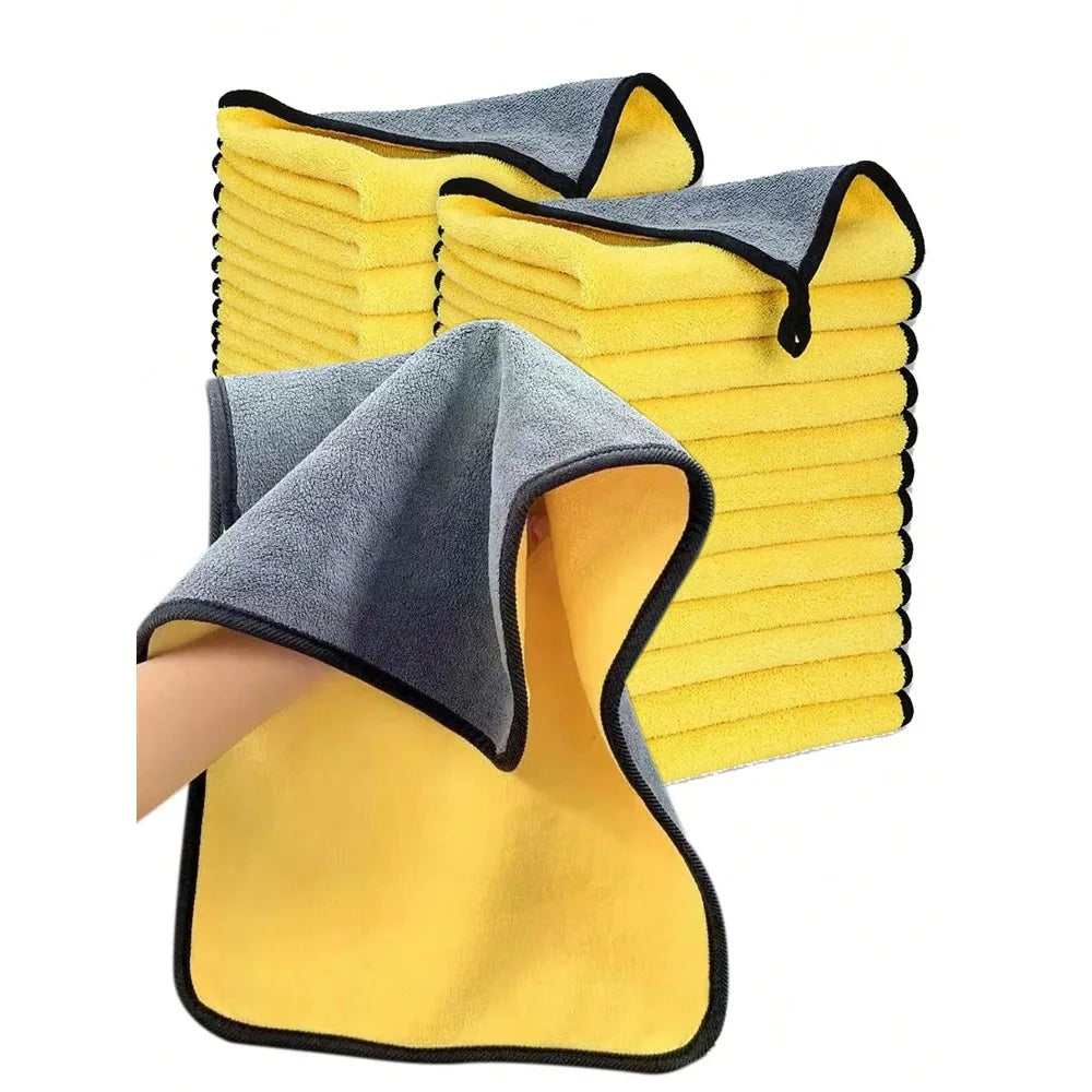 A set of yellow and gray microfiber car cleaning towels stacked together.