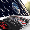 Close-up of a black car badge emblem decal for Ford models on a white surface.