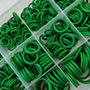 A collection of green rubber O-rings and gaskets arranged in a clear plastic tray.