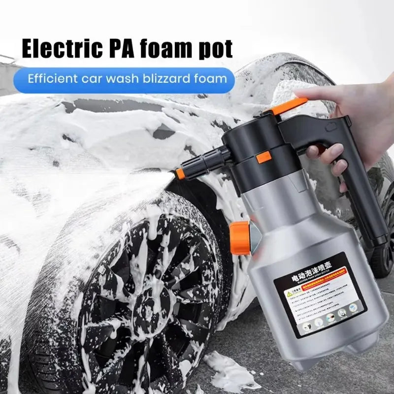 A hand is using an electric foam pot sprayer to apply blizzard foam on a car wheel.
