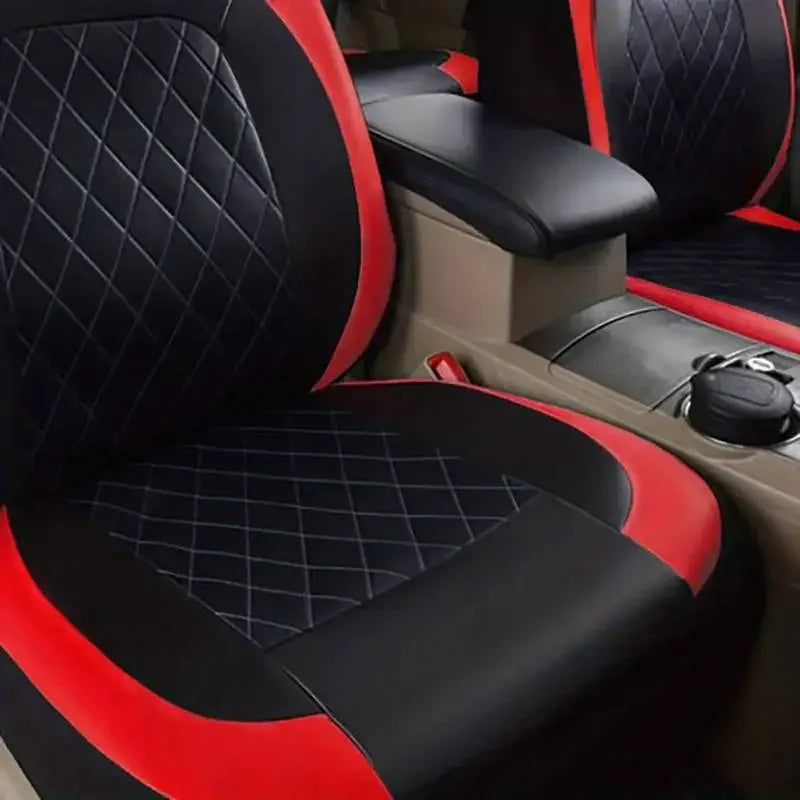 A close-up view of a black and red quilted car seat cover with a beige interior panel.