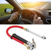 A handheld tire pressure gauge with a dual chuck inflator hose is shown against a white background.
