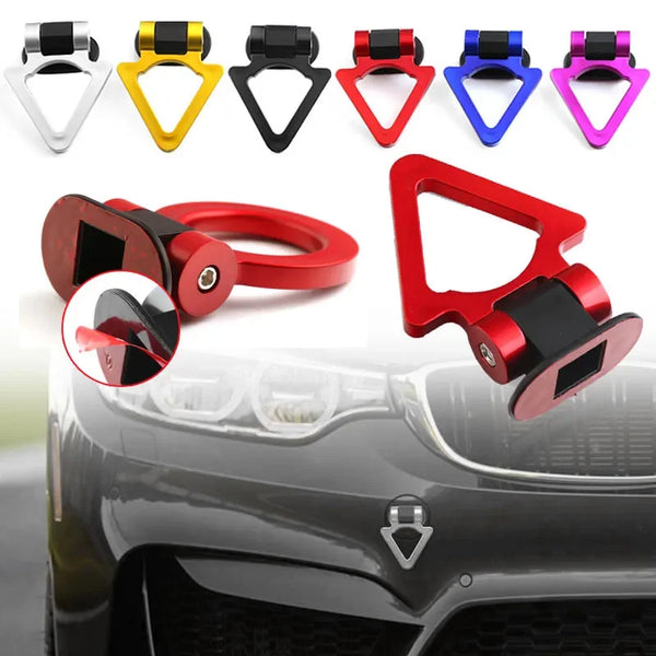 A collection of decorative racing tow hook stickers in various colors mounted on a car bumper.