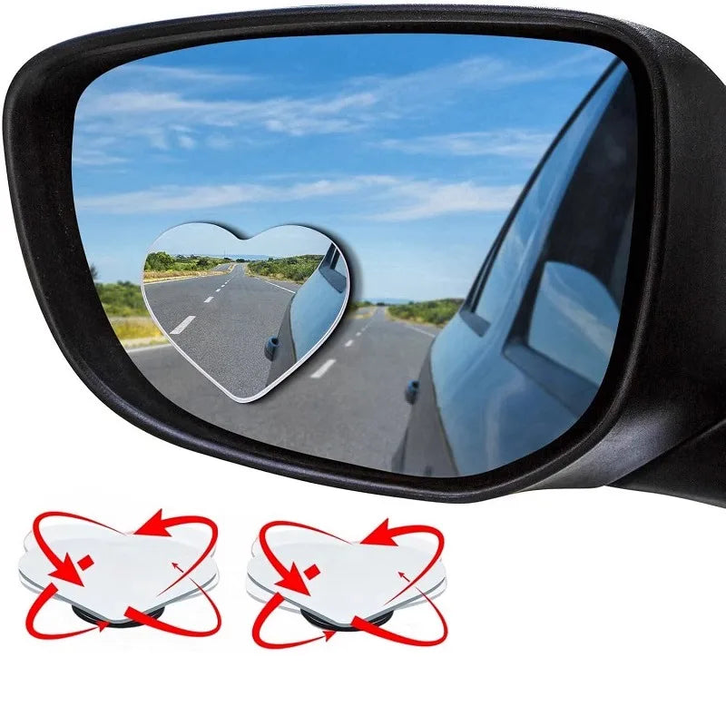 Heart-shaped rearview mirror set showing a view of a road and the sky.