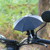 A black mini motorcycle sunshade umbrella is shown in an outdoor setting.