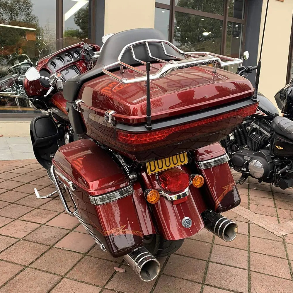 A close-up view of a red motorcycle with a universal car antenna mounted on the top rack.