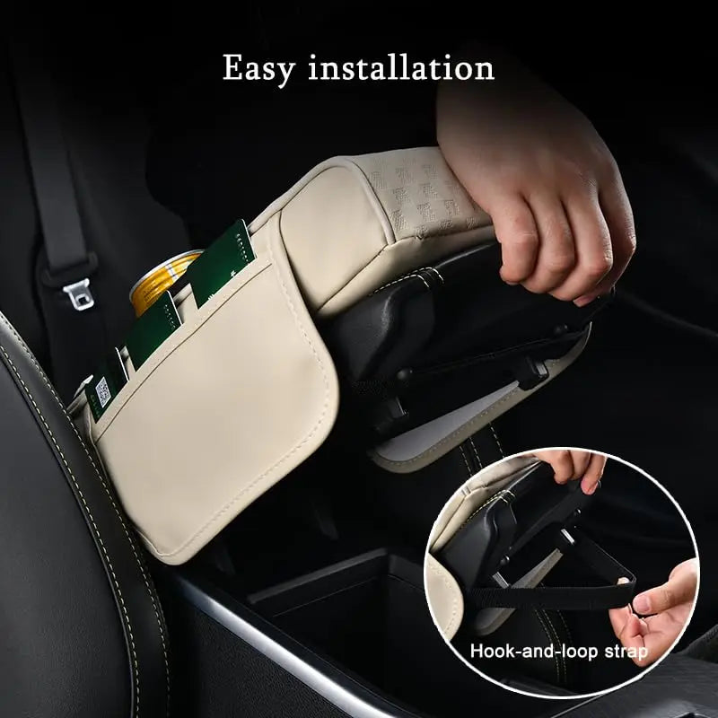 Hand installing a beige PU leather car armrest cushion with cup holders into a vehicle interior.