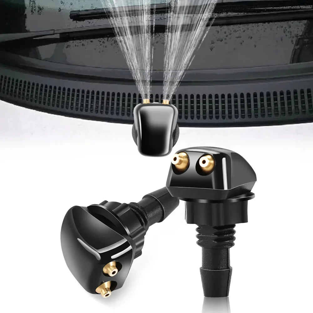 A black universal car windshield washer nozzle is shown spraying a fine mist onto a dark surface.