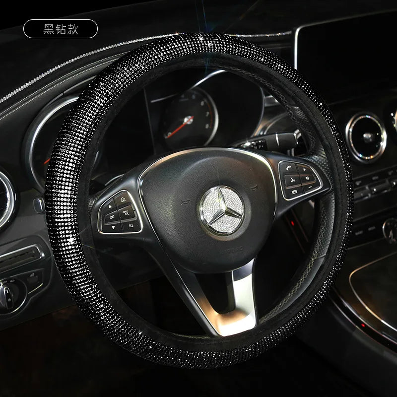 A black rhinestone bling steering wheel cover installed on a Mercedes-Benz interior.