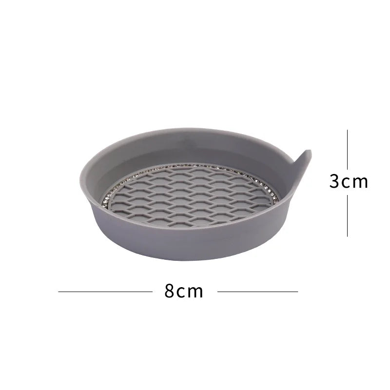 A gray silicone coaster with a textured surface and a rim, measuring 8cm by 3cm.