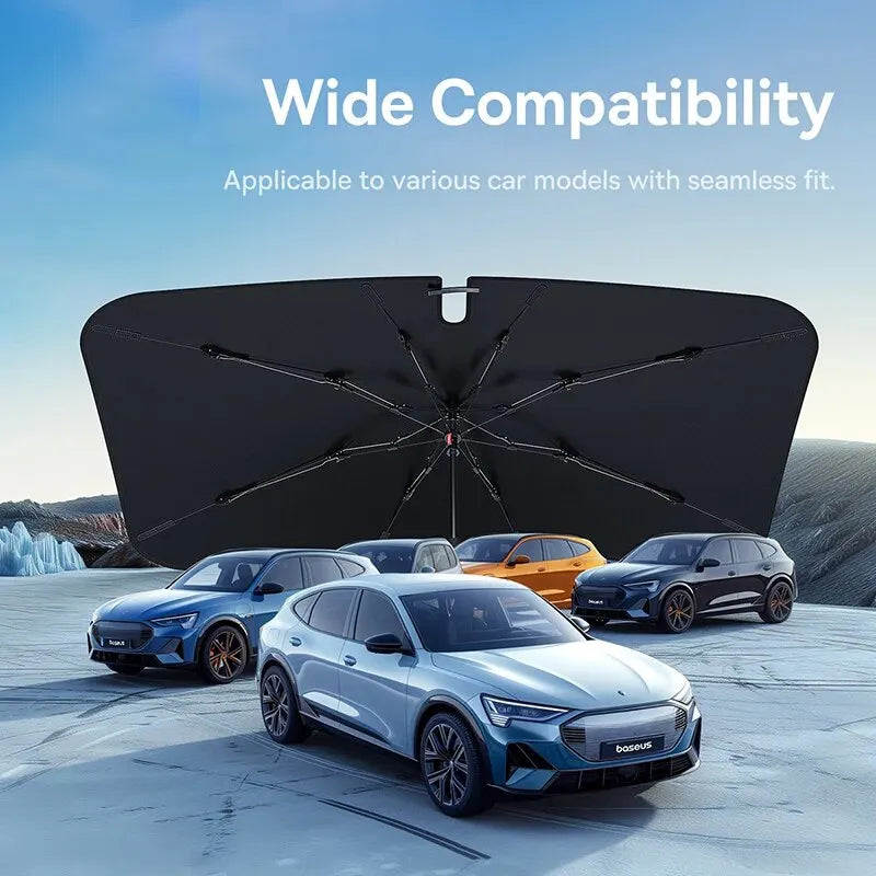 A dark car windshield sun shade umbrella is shown with several modern cars in a snowy outdoor setting.