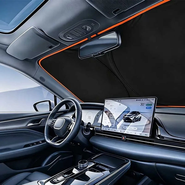 Interior view of a car showing an orange sun shade covering the windshield and a mounted tablet display.