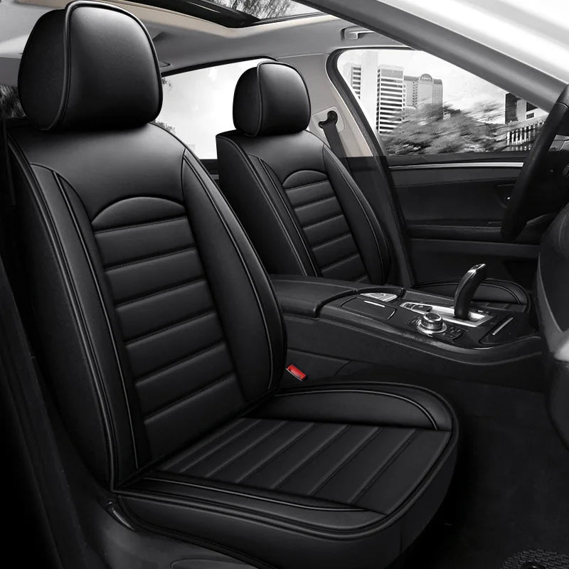 Interior view of a car with black leather seat covers installed on the front seats.