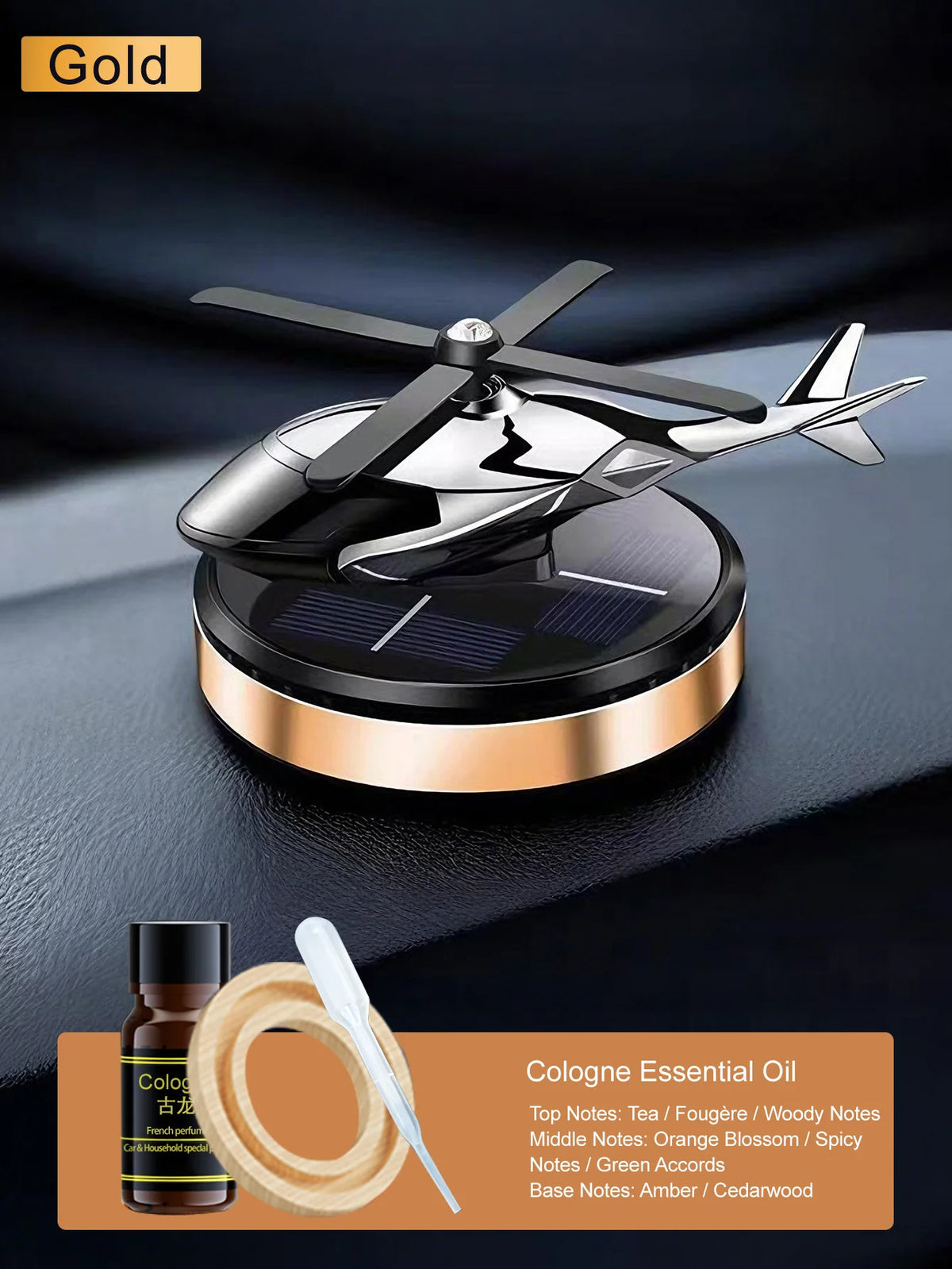 Parfum auto solaire doré rotatif avec boîtier noir et applicateur en bois sur une surface sombre.