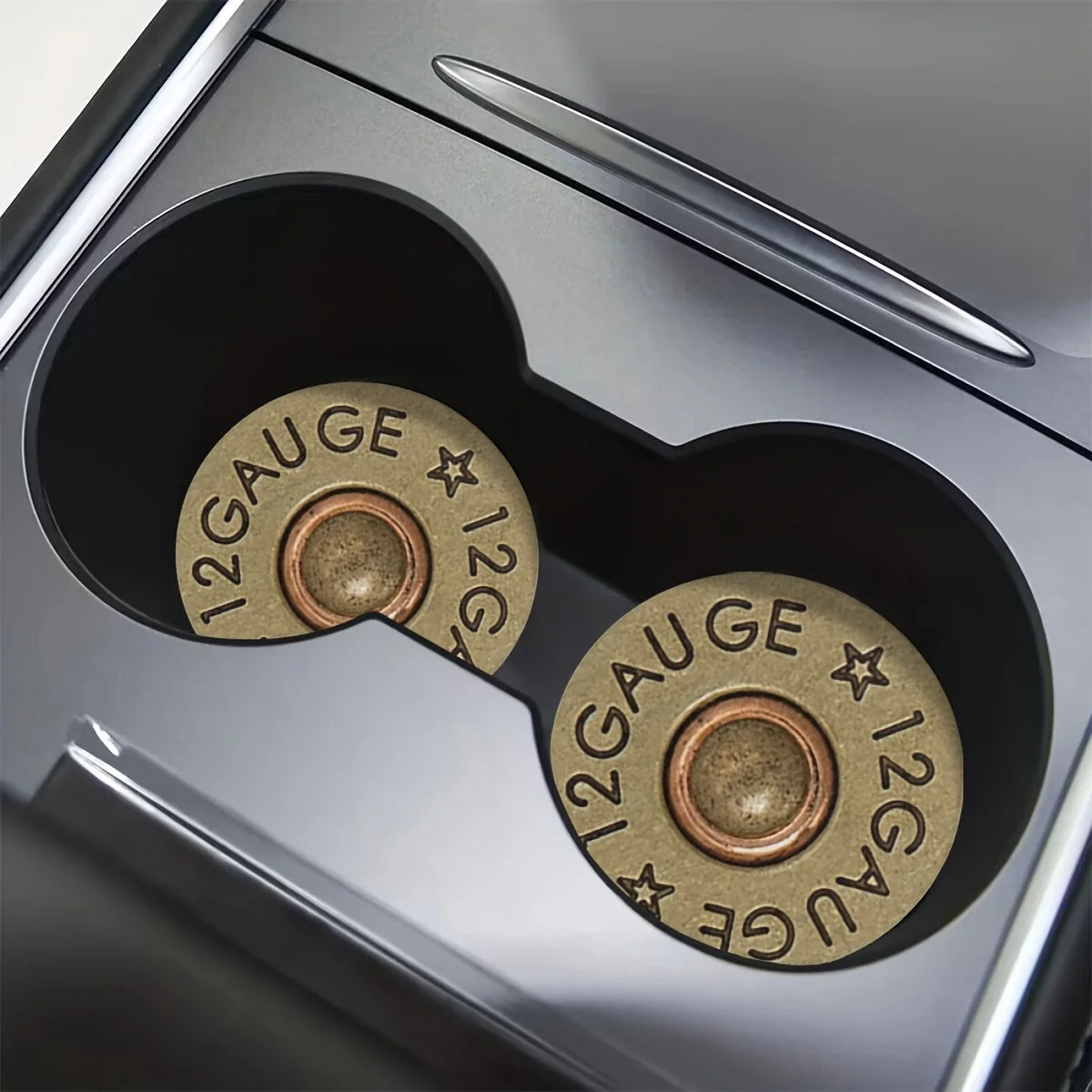 Close-up view of a silver car cup holder with two brass gauge-marked mats.