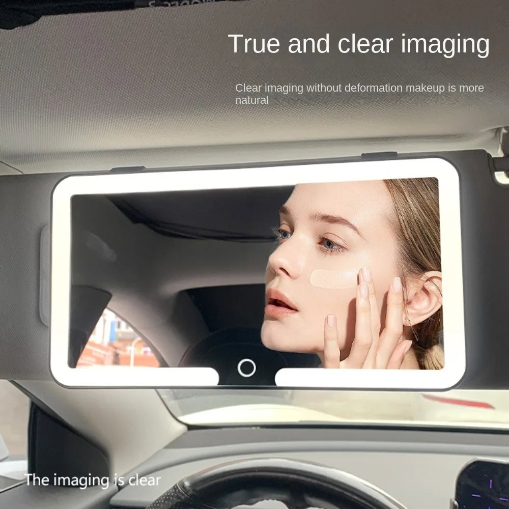 A touch screen vanity mirror is mounted in a car interior, showing a clear image of a woman's face.