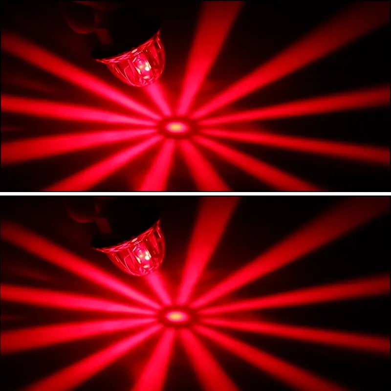 A close-up shot of a red LED light shining bright, creating radial beams against a dark background.
