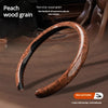 A close-up of a brown peach wood grain anti-slip steering wheel cover being shown in a car interior context.