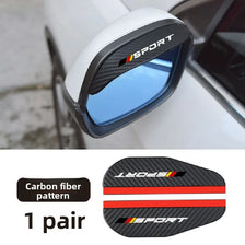 A pair of black carbon fiber sport rain deflectors for a car side mirror.