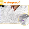 A hand pours liquid onto crumpled white paper, demonstrating the waterproof feature of a car cover.