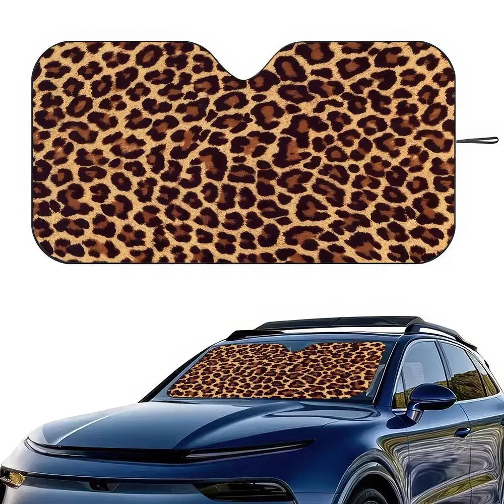 A leopard print car sunshade applied to the windshield of a blue car.