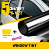 Close-up of a window tint film roll and a pink scraper for automotive window tinting.